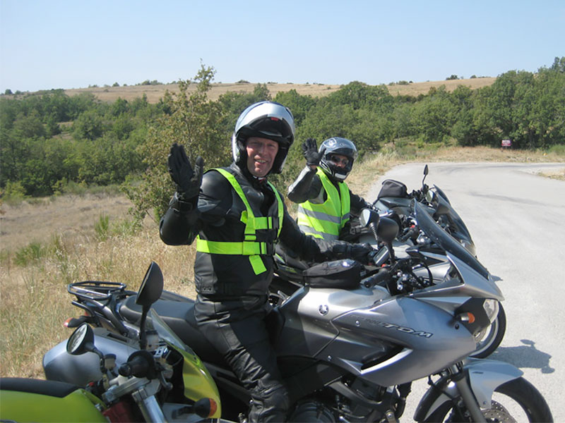 Derek Digital and another biker sitting on their motorbikes and waving
