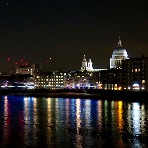 City of London nighttime skyline and reflection in the River Thames